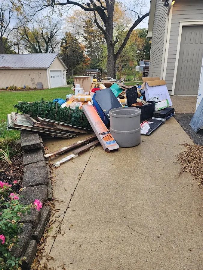 Dumpster being loaded with debris for Estate Cleanout Dumpster Rental in Seat Pleasant